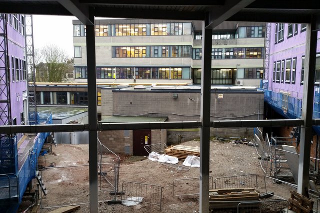 Looking out from a link corridor towards the current building.