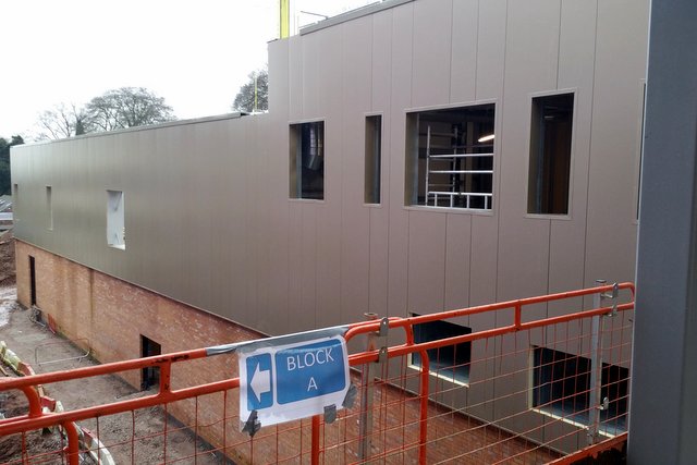 The Sports Hall and Performing Arts block is already fitted with metallic cladding.